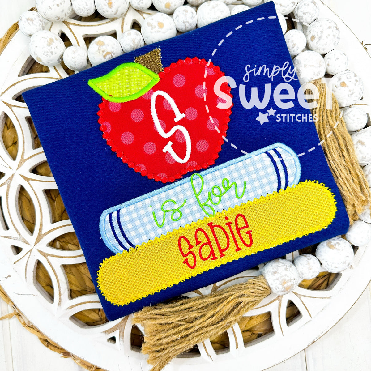1110 - STACKED BOOKS WITH APPLE - APPLIQUE CHILD SHIRT