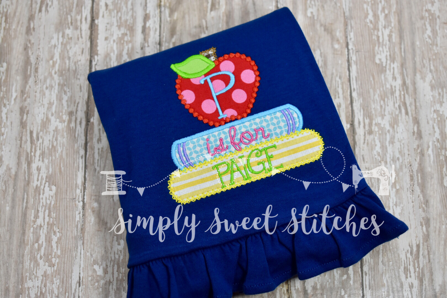 1110 - STACKED BOOKS WITH APPLE - APPLIQUE CHILD SHIRT